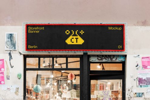 Editable storefront banner mockup on urban shop facade, perfect for designers to display branding projects, located in Berlin.